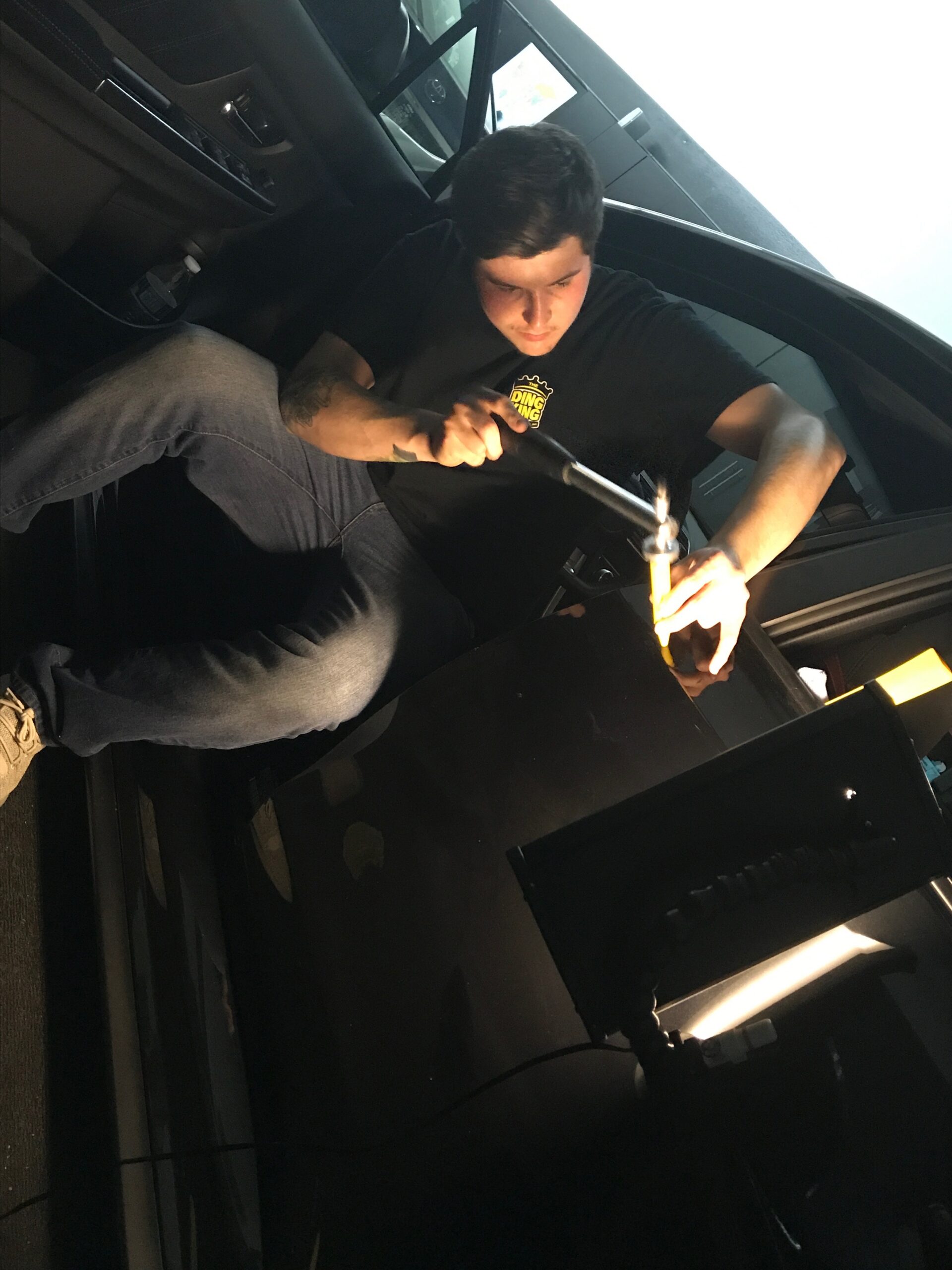 Madison Dent Repair team member assisting a customer beside a vehicle